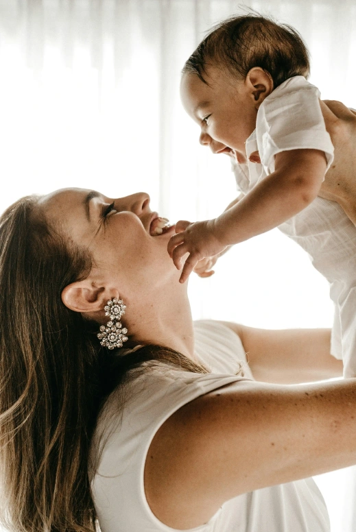 Woman holding a baby against her